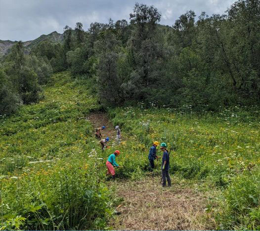 Volunteers clear vegetation from the trail in Zeskho, Georgia.
