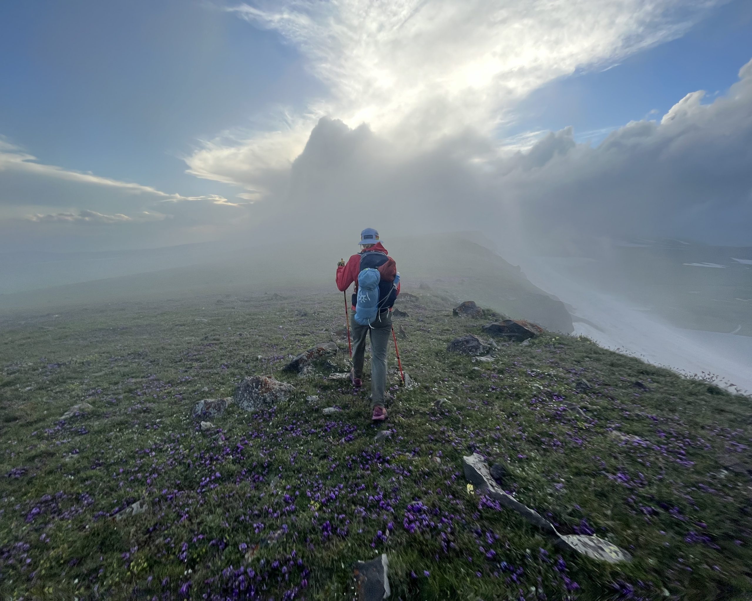 Geghams Day 2: Walking along a ridge in the fog, looking for a way to descend around the snowfields to set up camp for the night.