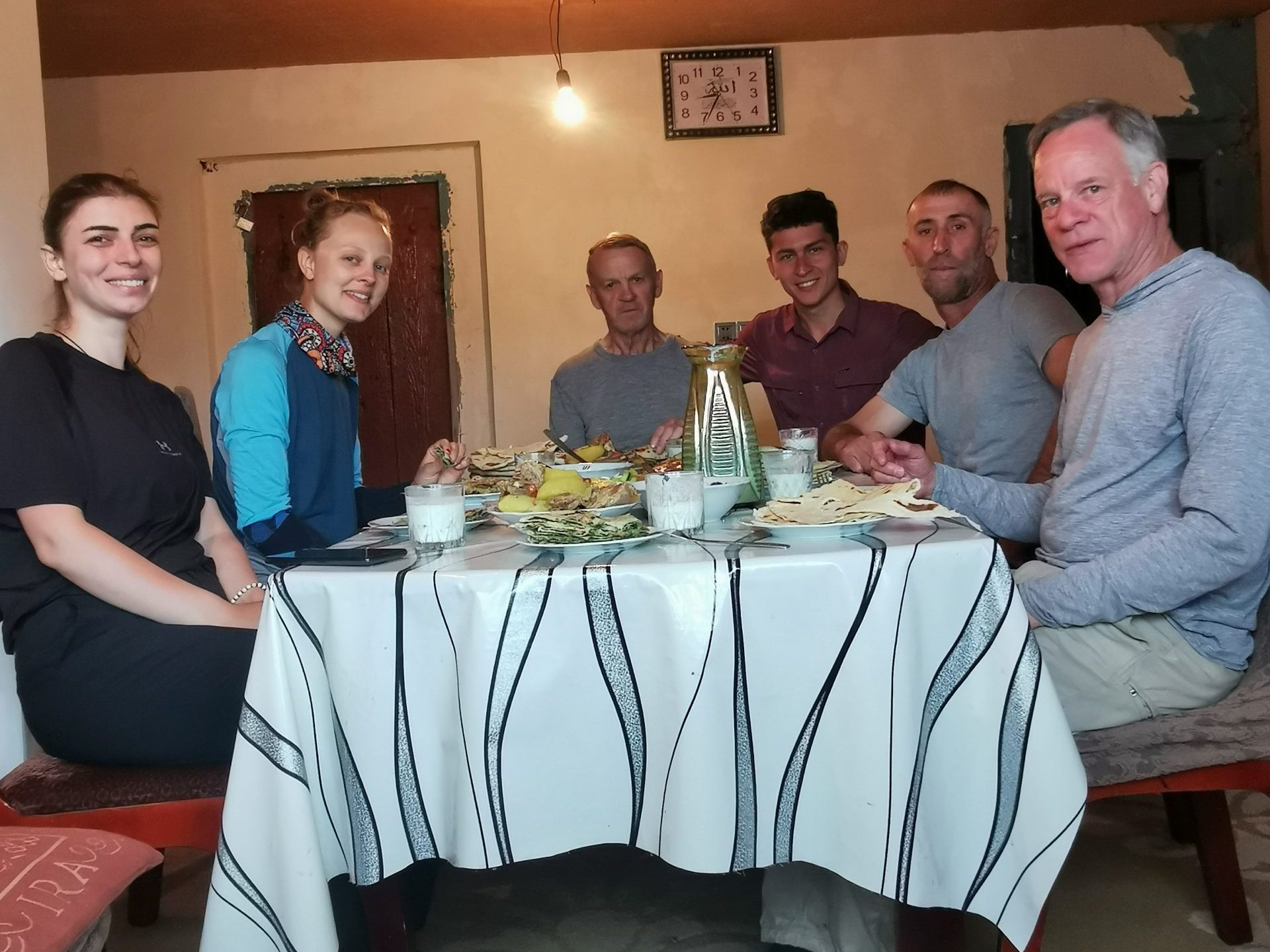 TCT supporters' trekkers join their host for a meal at his guesthouse.