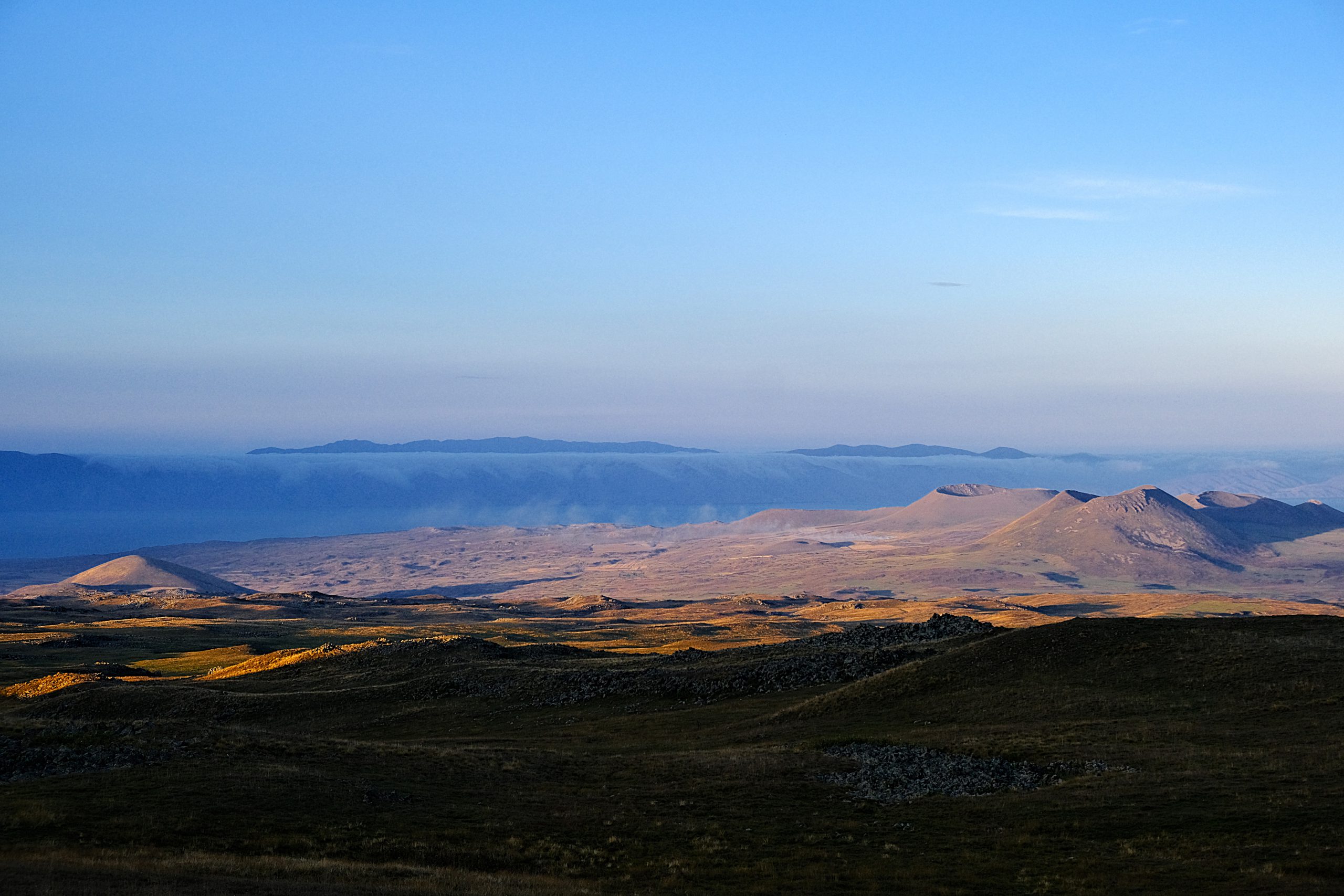 View from the campsite towards cloud-covered Lake Sevan.